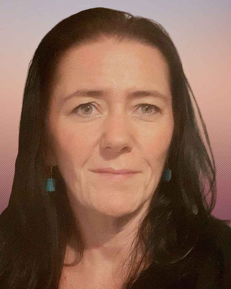 Don McJimpsey, art psychotherapist, with long dark hair and teal earrings